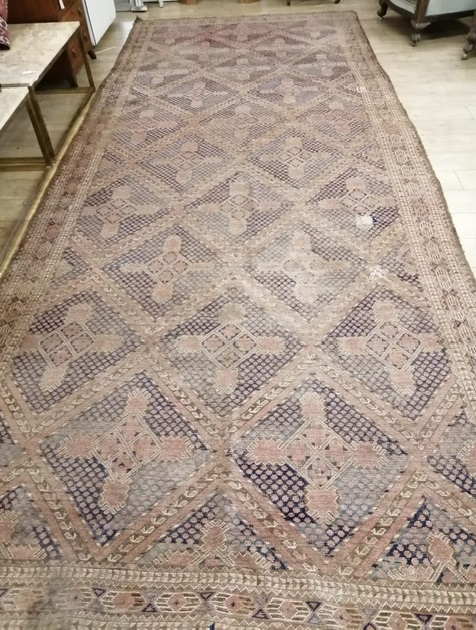 A large Caucasian hall carpet (worn) 498 x 206cm